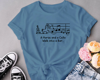 Blue t-shirt with humorous design and text, placed on a gray surface with sneakers and flowers.